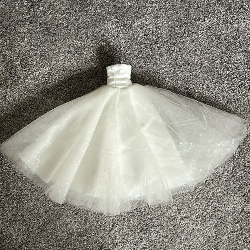 Single hand made wedding dress to fit over a wine bottle.